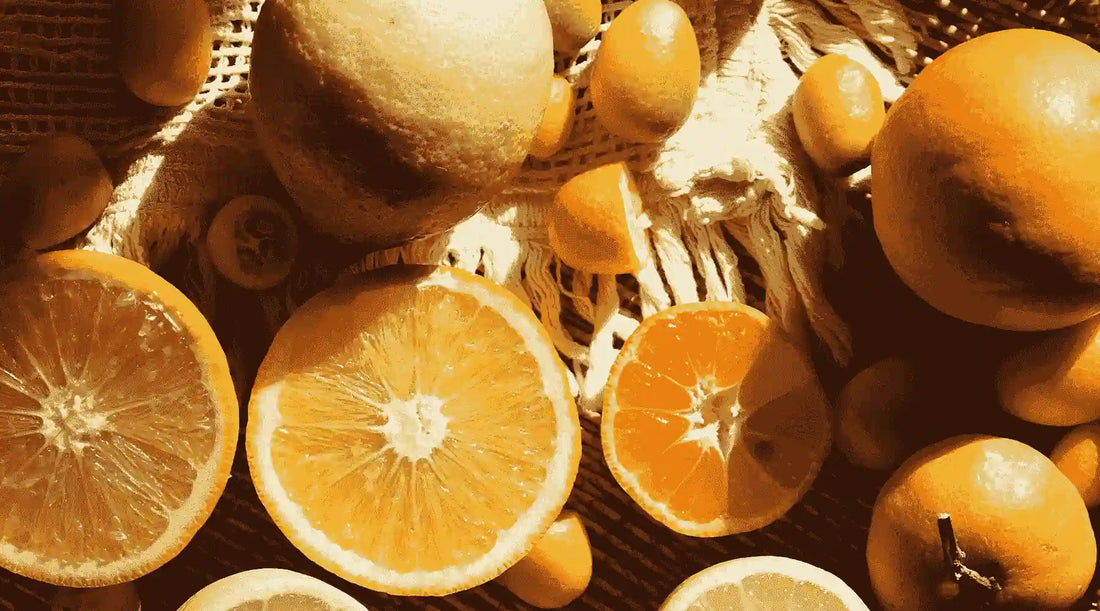 Bowl of oranges, some full, some cut in half